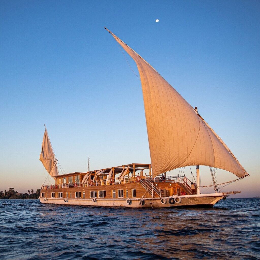 A dahabiya under sail on the Nile at dusk